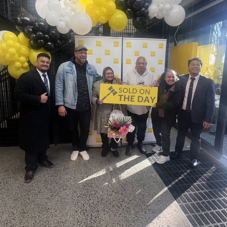 Clients celebrating a sale on auction day at Ray White Manukau